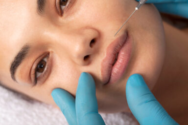Young woman undergoing procedure of bb glow treatment in beauty salon