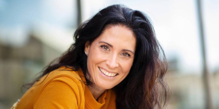 Portrait of beautiful caucasian woman smiling outdoors