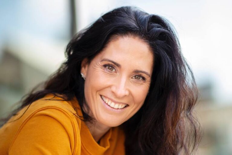 Portrait of beautiful caucasian woman smiling outdoors